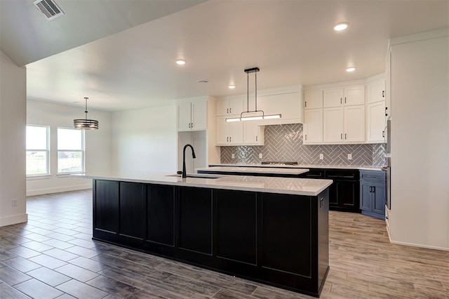 9321 NW 147th Ter, Yukon, OK 73099 - kitchen featuring light countertops, backsplash, white cabinetry, stainless steel appliances, and recessed lighting