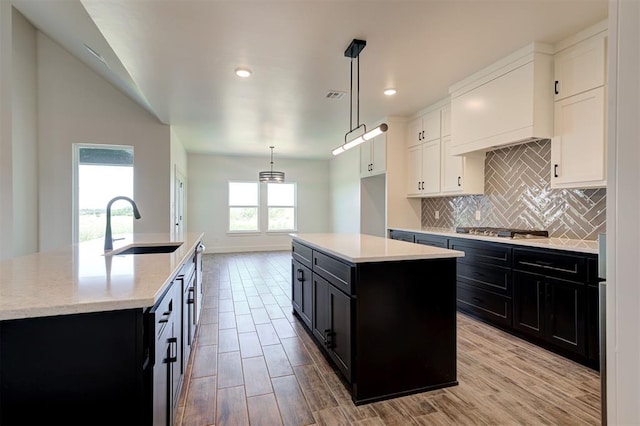 9321 NW 147th Ter, Yukon, OK 73099 - kitchen with a center island with sink, dark cabinetry, tasteful backsplash, and recessed lighting