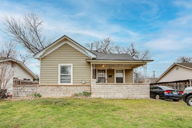 1011 NW 31st St, Oklahoma City, OK 73118 - bungalow with a front lawn, fence, covered porch, and a shingled roof