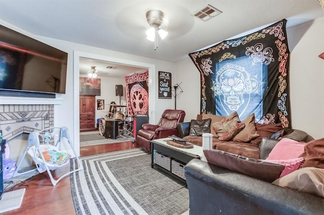 1011 NW 31st St, Oklahoma City, OK 73118 - living room with visible vents, a fireplace, ceiling fan, and wood finished floors