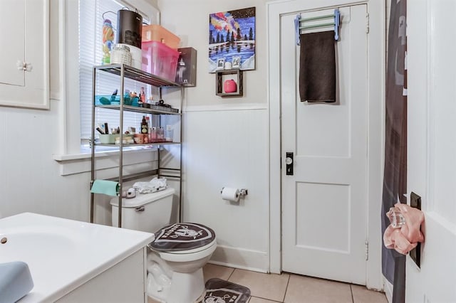 1011 NW 31st St, Oklahoma City, OK 73118 - bathroom featuring vanity, tile patterned floors, toilet, and wainscoting