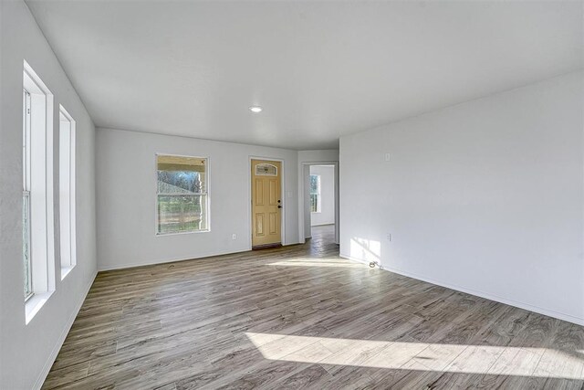 empty room with wood finished floors and baseboards
