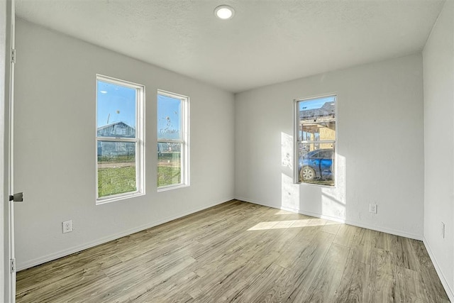 unfurnished room featuring baseboards and wood finished floors