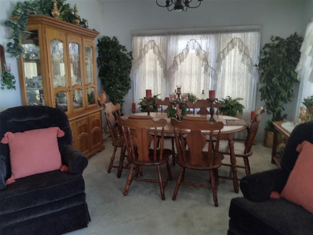 2005 E Cherokee Ave, Enid, OK 73701 - dining area with healthy amount of natural light, light carpet, and a chandelier