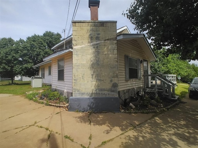 2005 E Cherokee Ave, Enid, OK 73701 - view of side of home with a chimney