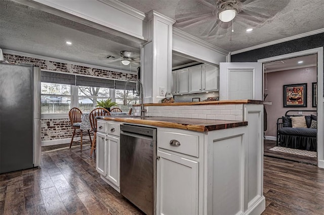 kitchen with stainless steel appliances, wood counters, and ceiling fan