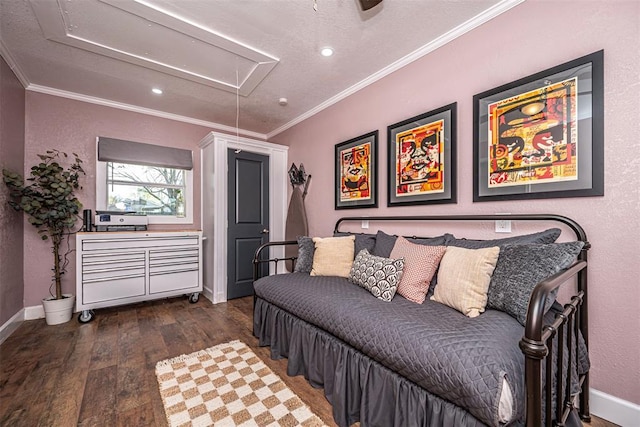 bedroom with wood finished floors, attic access, baseboards, and ornamental molding