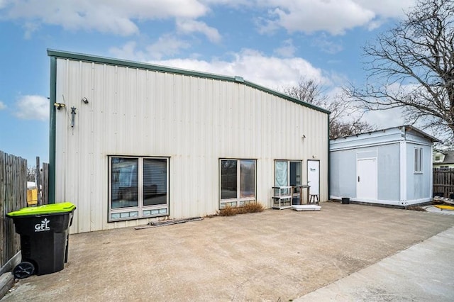 1333 W 1st St, Wewoka, OK 74884 - rear view of property featuring an outbuilding, a patio area, a storage unit, and fence