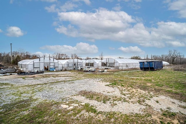 1333 W 1st St, Wewoka, OK 74884 - view of yard featuring a greenhouse and an outdoor structure