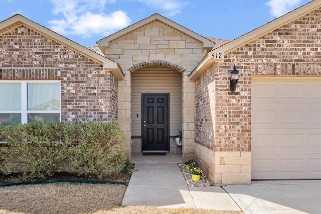property entrance featuring brick siding and a garage