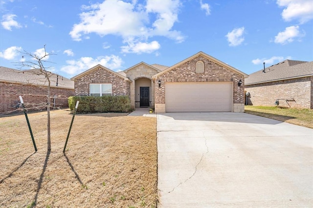 view of front facade with a garage, a front yard, brick siding, and driveway