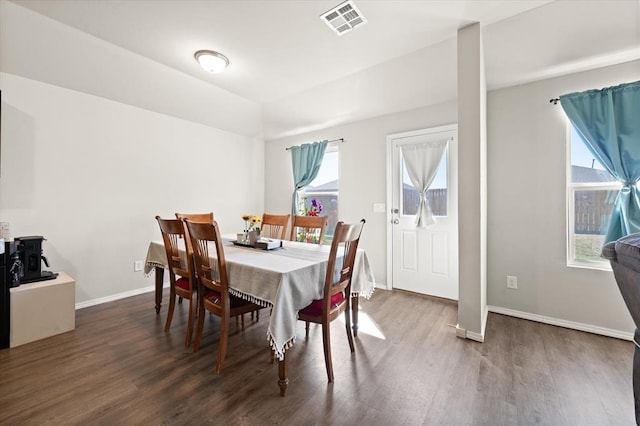dining room featuring wood finished floors, visible vents, and baseboards
