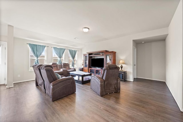 living area featuring baseboards and wood finished floors