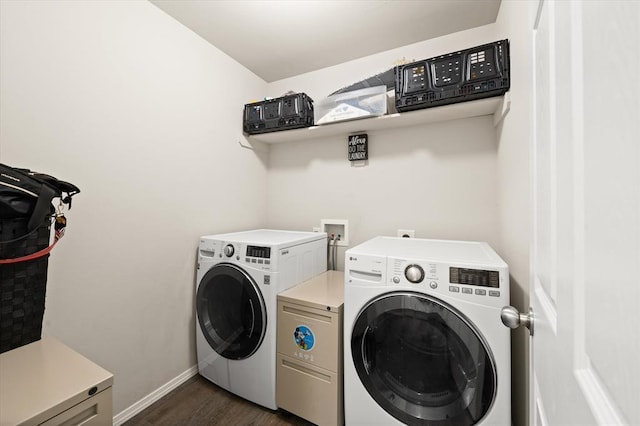 washroom featuring laundry area, dark wood-style floors, baseboards, and washing machine and clothes dryer