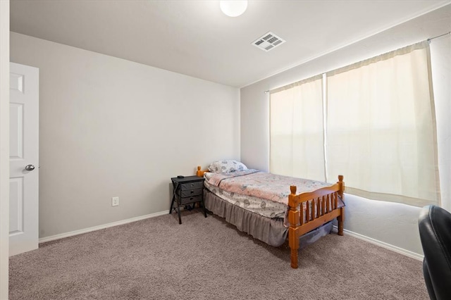 bedroom featuring visible vents, carpet flooring, and baseboards