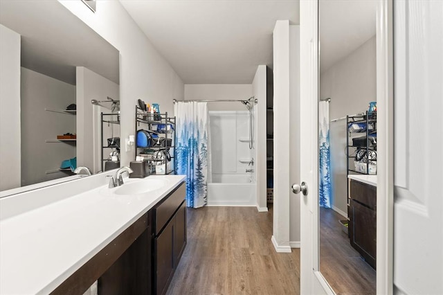 full bath featuring shower / tub combo with curtain, wood finished floors, and vanity
