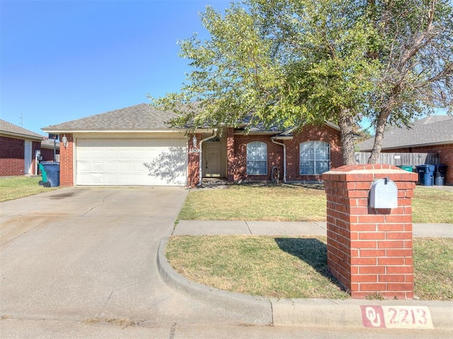 ranch-style house with brick siding, an attached garage, concrete driveway, and a front yard