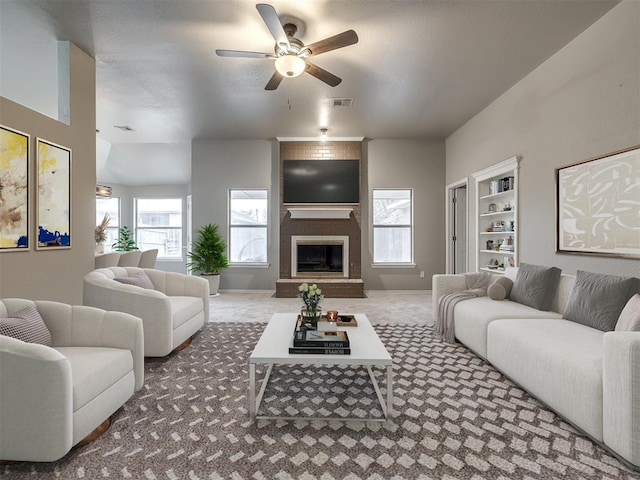 living area with baseboards, visible vents, a fireplace, ceiling fan, and carpet flooring
