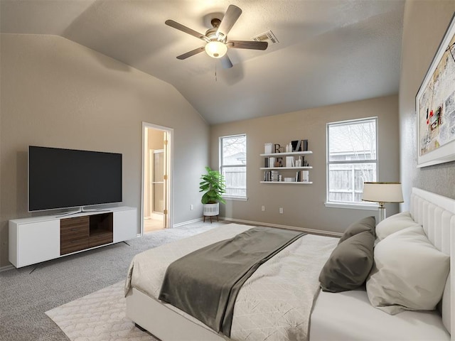 carpeted bedroom featuring visible vents, a ceiling fan, ensuite bath, baseboards, and vaulted ceiling