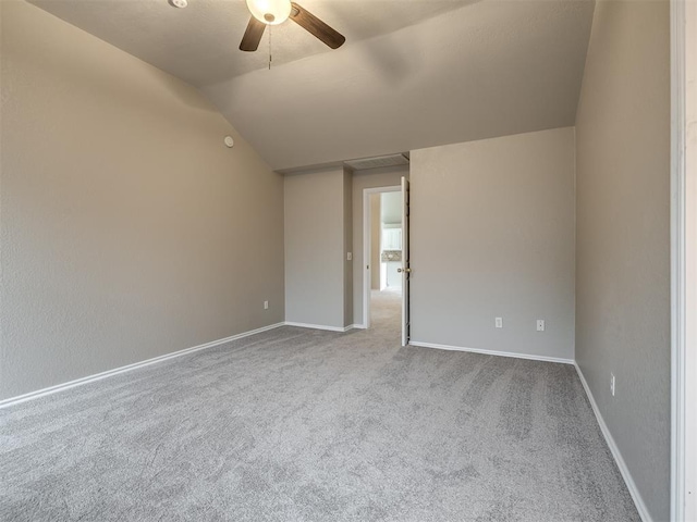 spare room with baseboards, carpet, lofted ceiling, and a ceiling fan