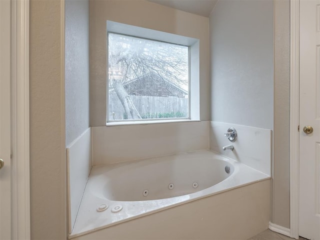 full bathroom featuring a tub with jets