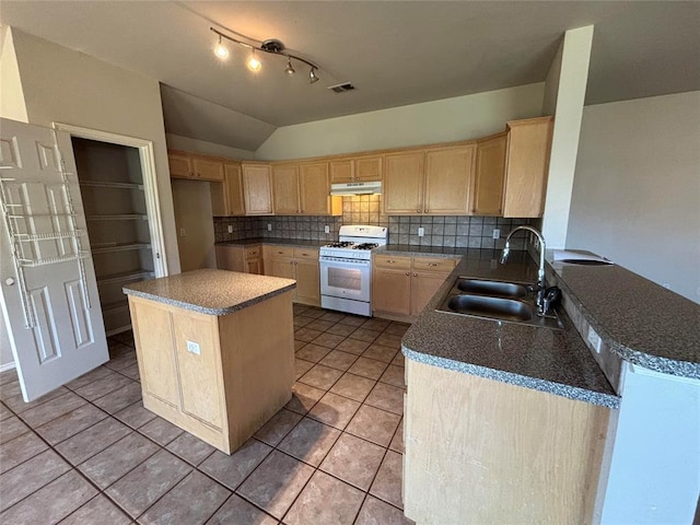 kitchen featuring a sink, light brown cabinets, under cabinet range hood, and white range with gas cooktop