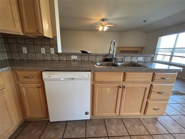 kitchen with a ceiling fan, white dishwasher, tasteful backsplash, a sink, and light tile patterned floors