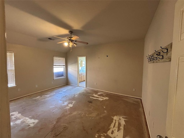 unfurnished bedroom featuring baseboards, ensuite bathroom, visible vents, and ceiling fan