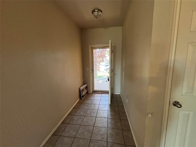 entryway featuring light tile patterned flooring and baseboards