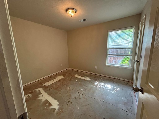 unfurnished room with visible vents