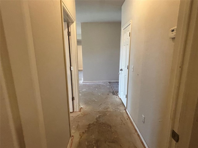 hall with unfinished concrete floors