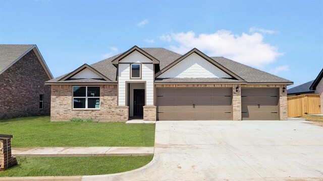 5502 Windstone Ln, Norman, OK 73072 - view of front of property featuring concrete driveway, a garage, a shingled roof, and brick siding