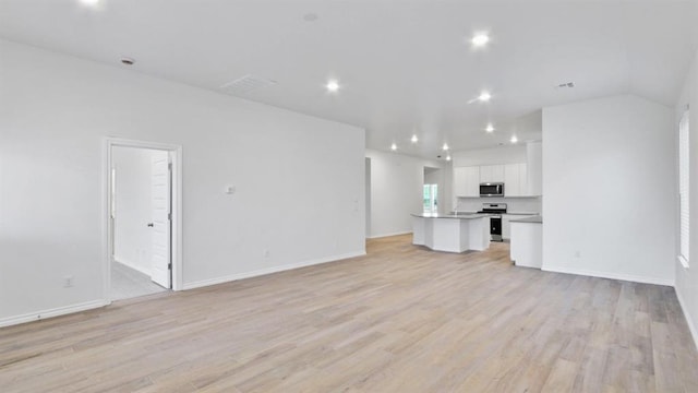 5502 Windstone Ln, Norman, OK 73072 - unfurnished living room with light wood-type flooring and recessed lighting