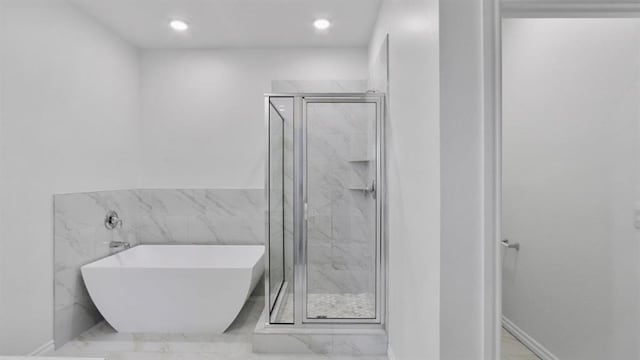 5502 Windstone Ln, Norman, OK 73072 - bathroom featuring a soaking tub, a marble finish shower, marble finish floors, and recessed lighting