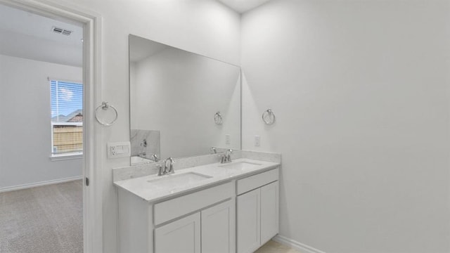 5502 Windstone Ln, Norman, OK 73072 - bathroom featuring double vanity and baseboards