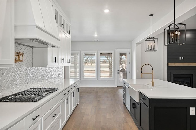 2215 Winter Creek Blvd, Blanchard, OK 73010 - kitchen with custom exhaust hood, light countertops, and stainless steel gas cooktop
