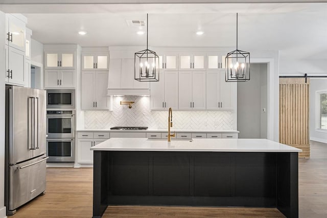 2215 Winter Creek Blvd, Blanchard, OK 73010 - kitchen with a chandelier, appliances with stainless steel finishes, light countertops, and a sink