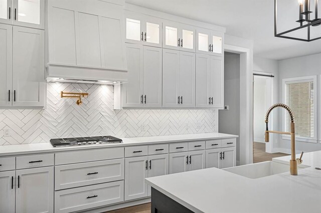 2215 Winter Creek Blvd, Blanchard, OK 73010 - kitchen featuring stainless steel gas stovetop, white cabinets, light countertops, and a sink