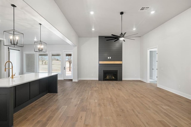 2215 Winter Creek Blvd, Blanchard, OK 73010 - kitchen featuring light countertops, wood finished floors, visible vents, and baseboards