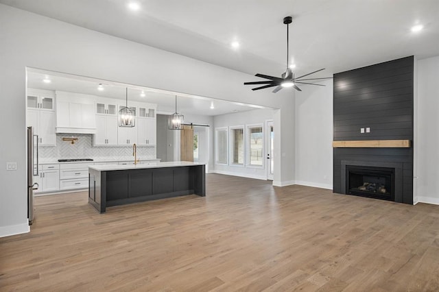 2215 Winter Creek Blvd, Blanchard, OK 73010 - kitchen featuring white cabinetry, freestanding refrigerator, black stovetop, light countertops, and ceiling fan