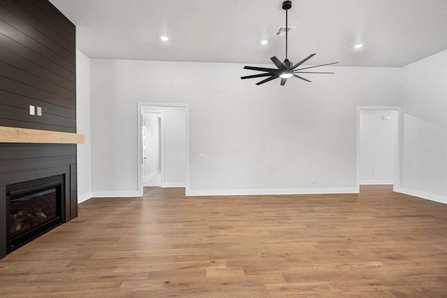 2215 Winter Creek Blvd, Blanchard, OK 73010 - unfurnished living room featuring visible vents, a large fireplace, light wood-style floors, baseboards, and ceiling fan