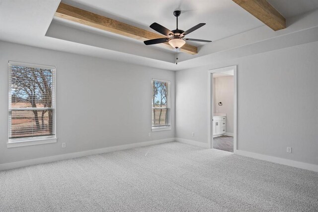 2215 Winter Creek Blvd, Blanchard, OK 73010 - unfurnished bedroom featuring beamed ceiling, baseboards, a raised ceiling, and carpet