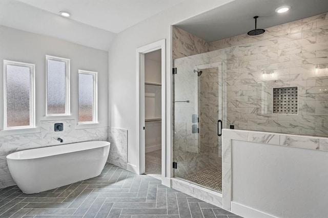 2215 Winter Creek Blvd, Blanchard, OK 73010 - bathroom with recessed lighting, tile walls, a shower stall, a freestanding bath, and a spacious closet