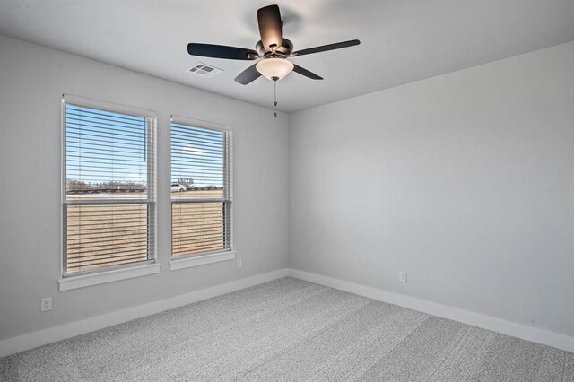 2215 Winter Creek Blvd, Blanchard, OK 73010 - carpeted spare room with visible vents, baseboards, and a ceiling fan