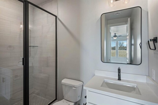 2215 Winter Creek Blvd, Blanchard, OK 73010 - full bath featuring vanity, toilet, a stall shower, and a ceiling fan