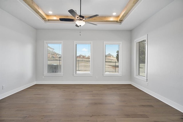 2215 Winter Creek Blvd, Blanchard, OK 73010 - spare room with dark wood finished floors, a raised ceiling, a healthy amount of sunlight, and baseboards