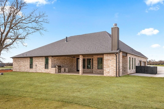2215 Winter Creek Blvd, Blanchard, OK 73010 - back of property featuring a lawn, a patio, roof with shingles, brick siding, and a chimney
