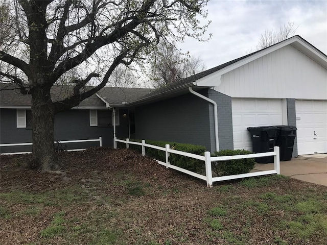 1310 SW 77th Ter, Oklahoma City, OK 73159 - view of front of home with brick siding, concrete driveway, an attached garage, and fence