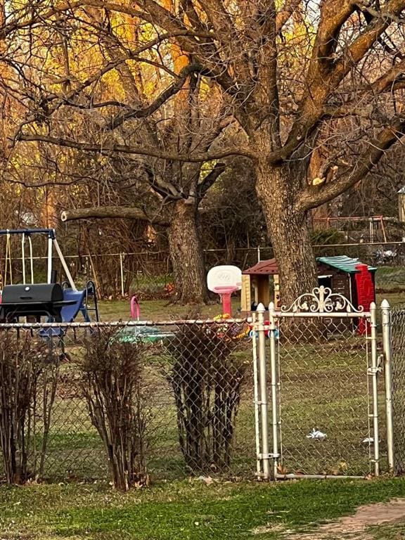 504 N Midwest Blvd, Midwest City, OK 73110 - view of yard with a playground, a gate, and fence
