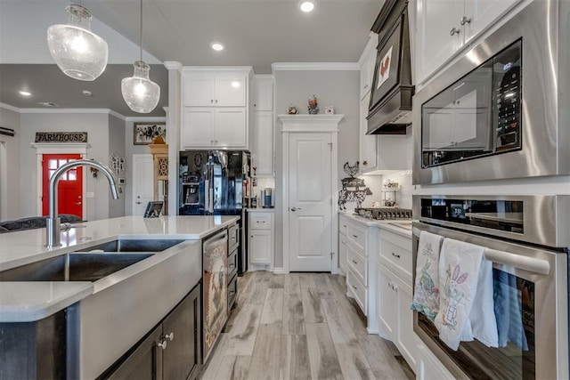 1624 NE 32nd St, Moore, OK 73160 - kitchen featuring stainless steel appliances, light countertops, ornamental molding, decorative light fixtures, and white cabinetry